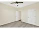 Bedroom with a ceiling fan and two doors, carpet floors, and light-colored walls at 3301 N 200 W, Franklin, IN 46131