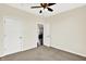 Bedroom with ceiling fan, 2 doors, and view into another room. Carpeted floor at 3301 N 200 W, Franklin, IN 46131