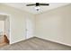 Carpeted bedroom with a ceiling fan and a white door; neutral wall paint at 3301 N 200 W, Franklin, IN 46131