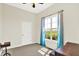 Bedroom featuring a large window with curtains and neutral paint. Ceiling fan at 3301 N 200 W, Franklin, IN 46131