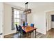 Dining room features wooden table, stylish light fixture, and view to the exterior at 3301 N 200 W, Franklin, IN 46131