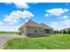 Home featuring a well-manicured lawn, a gravel driveway, and a rear patio at 3301 N 200 W, Franklin, IN 46131