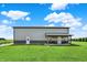Beautiful barndominium on a green lawn with covered porch and a blue sky on a sunny day at 3301 N 200 W, Franklin, IN 46131