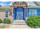 Inviting front porch with a wooden beam entry, gray door, and neatly trimmed bushes at 3301 N 200 W, Franklin, IN 46131