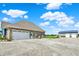 Spacious home and two garages, with a gravel driveway and a view of a green field at 3301 N 200 W, Franklin, IN 46131