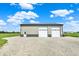 Detached garage offering multiple bays with ample space on a gravel yard at 3301 N 200 W, Franklin, IN 46131