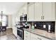 Well-lit kitchen features stainless steel appliances, granite counters and dark subway tile at 3301 N 200 W, Franklin, IN 46131