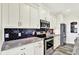 Modern kitchen features stainless steel appliances, granite countertops, and sleek black subway tile backsplash at 3301 N 200 W, Franklin, IN 46131