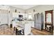 Eat-in kitchen area with an island, stainless steel refrigerator, and white cabinets at 3301 N 200 W, Franklin, IN 46131