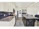 Open kitchen with a large island, white cabinets, stainless appliances and unique black subway tile backsplash at 3301 N 200 W, Franklin, IN 46131