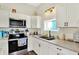 Well-lit kitchen features white cabinets, stainless steel appliances, and granite countertops at 3301 N 200 W, Franklin, IN 46131