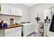Well-lit laundry room featuring a washer, dryer, storage, and modern decor at 3301 N 200 W, Franklin, IN 46131