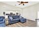 Spacious living room with fireplace and ceiling fan is open to kitchen with bar seating and stainless appliances at 3301 N 200 W, Franklin, IN 46131