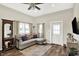 Cozy living room with a gray sofa, area rug and a ceiling fan. Large windows provide natural light at 3301 N 200 W, Franklin, IN 46131