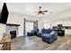 Bright living room featuring a fireplace, dark wood floors, and a comfortable-looking blue sectional sofa at 3301 N 200 W, Franklin, IN 46131