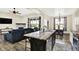 Open concept living space features large kitchen island, fireplace and living room with lots of windows at 3301 N 200 W, Franklin, IN 46131