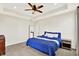 A main bedroom includes modern ceiling fan, a comfortable bed, and a glimpse into the attached bathroom at 3301 N 200 W, Franklin, IN 46131
