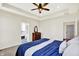 A main bedroom shows an ensuite bathroom, tray ceilings, fan and a glimpse of the doorway to hall at 3301 N 200 W, Franklin, IN 46131
