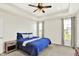 A bright main bedroom features tray ceilings, recessed lighting, and two windows with views of the surrounding landscape at 3301 N 200 W, Franklin, IN 46131