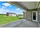 Covered outdoor patio with brick features overlooks the side yard, lawn, and agricultural fields at 3301 N 200 W, Franklin, IN 46131