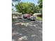 Wide driveway showcasing multiple parked cars, garage, and lush greenery in a tree-lined yard at 386 Shadow Hill Dr, Greenwood, IN 46142
