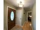 Inviting entryway features a decorative front door with glass insert, light-colored walls and durable laminate flooring at 386 Shadow Hill Dr, Greenwood, IN 46142