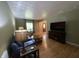 Bright living room features wood floors, large windows, and stylish furnishings, creating a cozy and inviting atmosphere at 386 Shadow Hill Dr, Greenwood, IN 46142