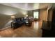 Bright living room features wood floors, large windows, and stylish furnishings, creating a cozy and inviting atmosphere at 386 Shadow Hill Dr, Greenwood, IN 46142