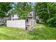 Wide view of a backyard with a wooden fence and access to the townhome and back deck at 392 Aspen Dr, Carmel, IN 46032