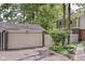 This home has a detached garage with a private entrance surrounded by mature trees and landscaping at 392 Aspen Dr, Carmel, IN 46032
