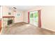 The living room features a fireplace, sliding glass doors and plush neutral carpeting at 392 Aspen Dr, Carmel, IN 46032