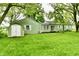 View of the backyard and shed, surrounded by mature trees at 415 N 3Rd St, Elwood, IN 46036