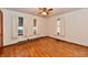 Bedroom featuring hardwood floors, three windows, and neutral walls at 415 N 3Rd St, Elwood, IN 46036