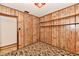 Bedroom with paneled walls, carpet, and built-in shelving at 415 N 3Rd St, Elwood, IN 46036