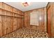 Bedroom with paneled walls, carpet, built-in shelving, and natural light from a window at 415 N 3Rd St, Elwood, IN 46036