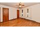 Bedroom featuring hardwood floors, multiple doorways, and three windows at 415 N 3Rd St, Elwood, IN 46036