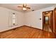 Spacious bedroom features hardwood floors, a ceiling fan, and natural light at 415 N 3Rd St, Elwood, IN 46036