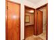 Hallway with multiple doorways, neutral walls, and carpeted floors at 415 N 3Rd St, Elwood, IN 46036