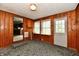 A unique living room with wooden panels and a glimpse into the kitchen creates an inviting space at 415 N 3Rd St, Elwood, IN 46036