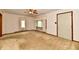 Cozy living room featuring classic carpet, neutral walls, and a ceiling fan at 415 N 3Rd St, Elwood, IN 46036