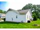 Back exterior view of home featuring a well-maintained lawn and siding at 4305 W Coyote Run Ct, Muncie, IN 47304