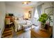 Comfortable bedroom showcasing a ceiling fan, natural light, and hardwood floors at 4305 W Coyote Run Ct, Muncie, IN 47304