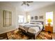 Bright bedroom featuring modern decor, multiple windows, and hardwood flooring at 4305 W Coyote Run Ct, Muncie, IN 47304
