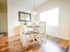 Cozy dining area with wood flooring, a round table with chairs, and natural light from a window at 4305 W Coyote Run Ct, Muncie, IN 47304