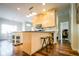 Bright kitchen featuring an island with bar seating, modern appliances, and wood flooring at 4305 W Coyote Run Ct, Muncie, IN 47304