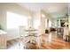 Open-concept area with dining table, lots of natural light, and view into the cozy living room at 4305 W Coyote Run Ct, Muncie, IN 47304