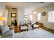 Spacious living room with hardwood floors, comfortable seating, and ample natural light at 4305 W Coyote Run Ct, Muncie, IN 47304