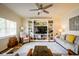 Comfortable living room featuring a large built-in shelving unit, neutral decor, and hardwood flooring at 4305 W Coyote Run Ct, Muncie, IN 47304