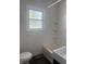 Bathroom showcasing a shower/tub combo, toilet and sink below a window for natural light at 4521 Vernon Ave, Indianapolis, IN 46226
