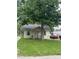 Quaint home featuring a front porch, mature trees, a lush green lawn, and a long driveway at 4521 Vernon Ave, Indianapolis, IN 46226